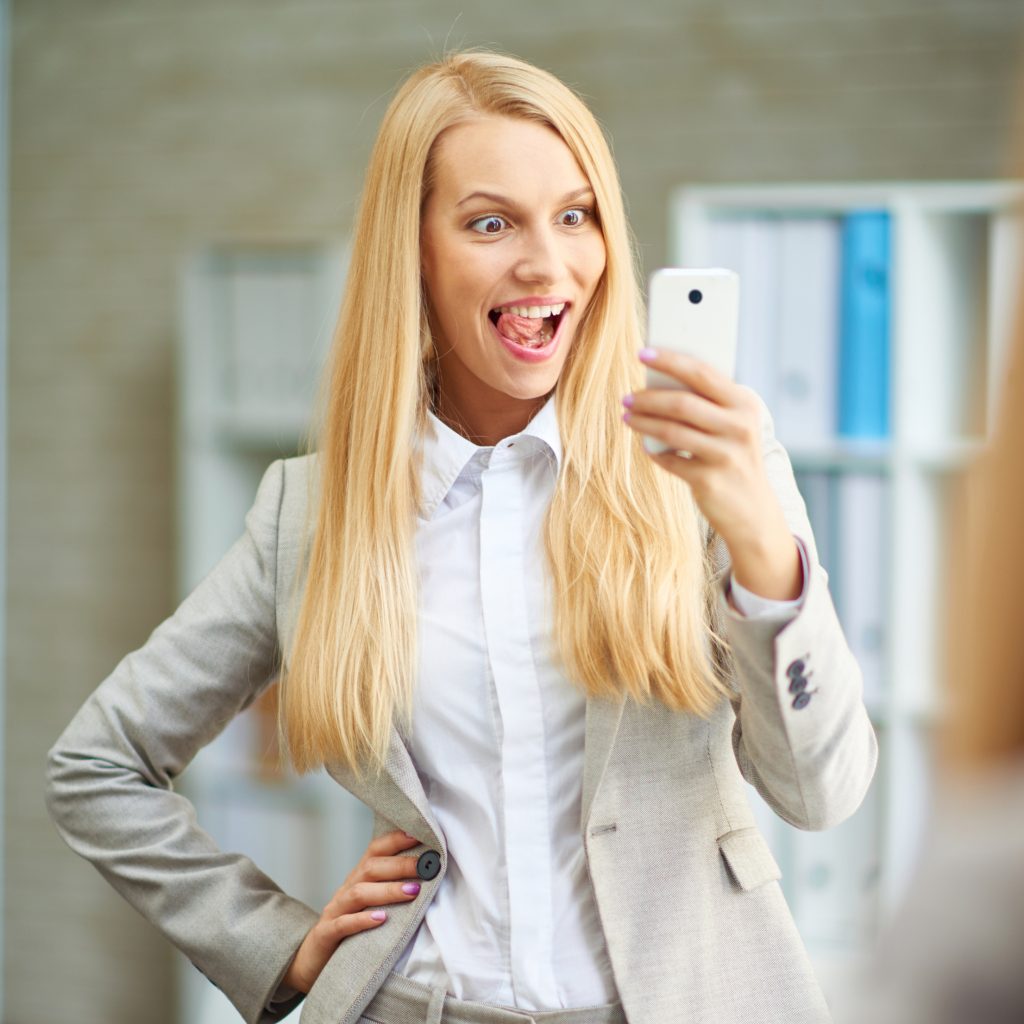 Businesswoman pulling face on Snapchat